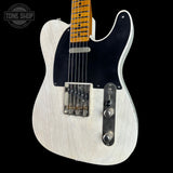 A white-finished electric guitar with a black pickguard, chrome hardware, and a natural wood fretboard, shown against a black background with a Tone Shop watermark in the top left.