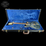 Electric guitar in a blue case with 'Tone Shop' logo.