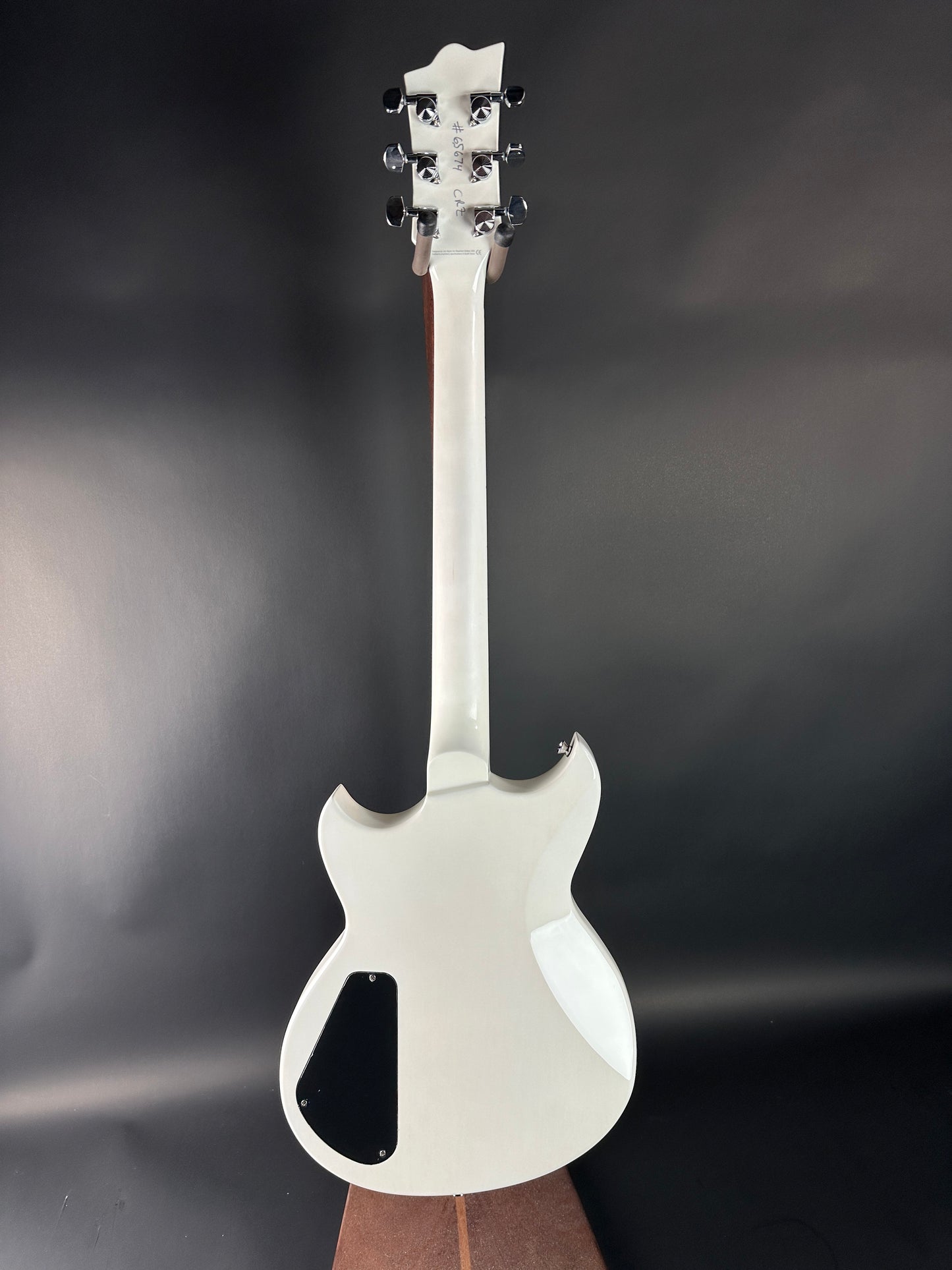 White electric guitar on a dark gray background