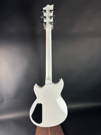 White electric guitar on a dark gray background