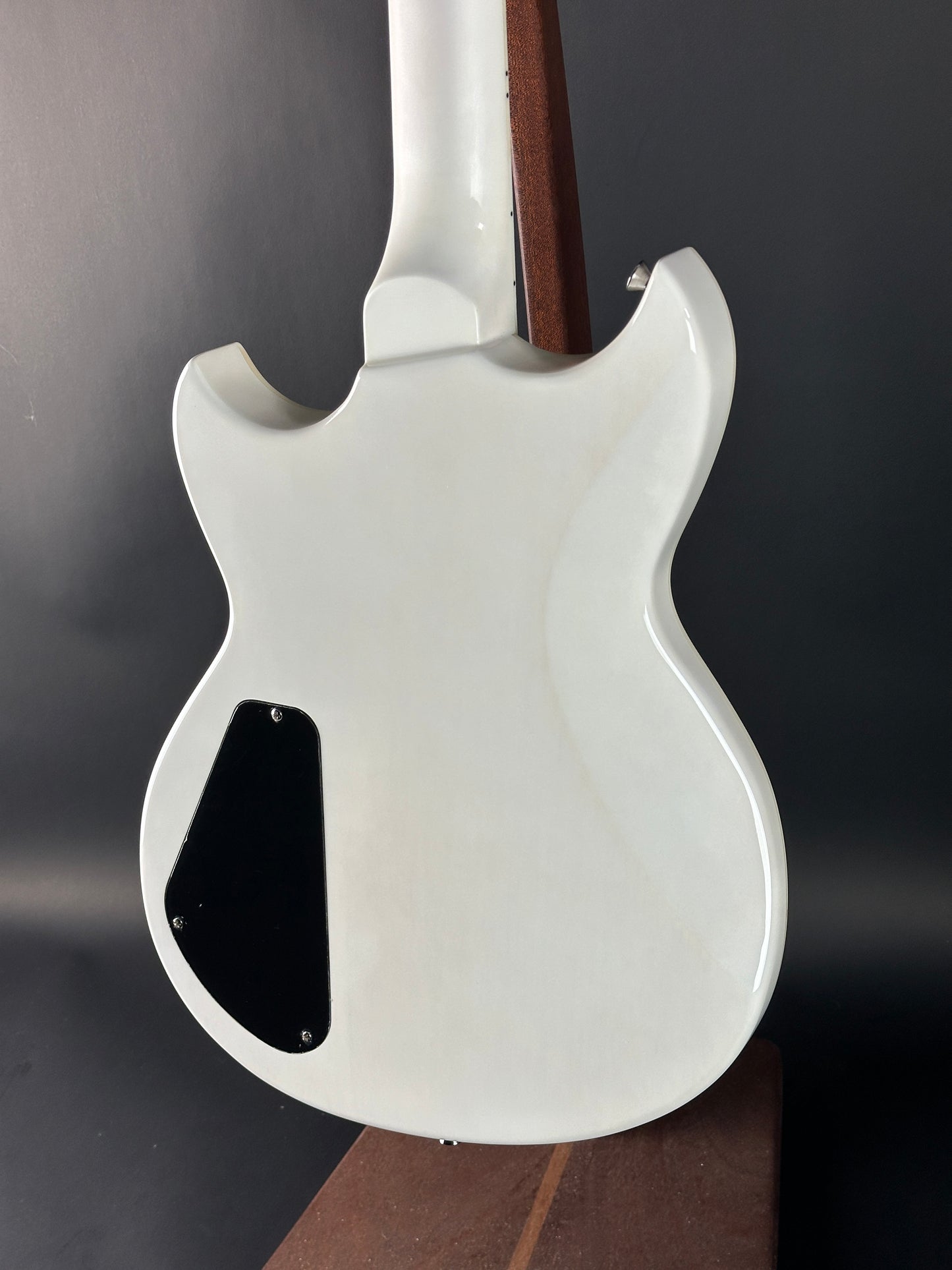 White electric guitar body on a dark background