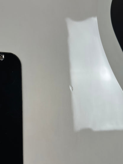 Close-up of a smartphone with a white object casting a shadow on a gray background