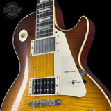 Electric guitar with a sunburst finish on a black background, featuring the Tone Shop logo.