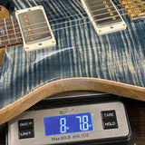 Guitar on a digital scale displaying weight