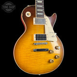 Electric guitar with a sunburst finish on a black background, featuring the Tone Shop logo.