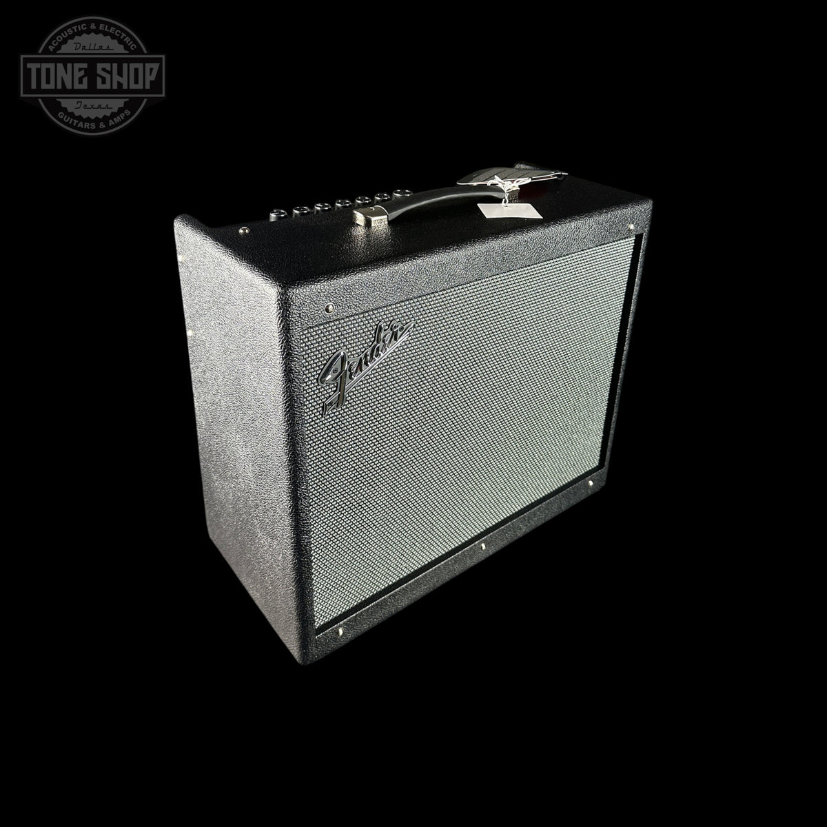 A Fender guitar amplifier speaker cabinet with a black textured exterior and a silver-gray front grille, shown at an angle on a solid black background. A Tone Shop watermark is visible in the top-left corner.
