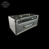 A BadCat Classic 80 guitar amplifier head in textured gray metal, shown at a three-quarter angle against a solid black background. The BadCat logo is clearly visible on the front panel.