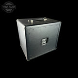 Black guitar amplifier cabinet on a white background with 'Tone Shop' logo.
