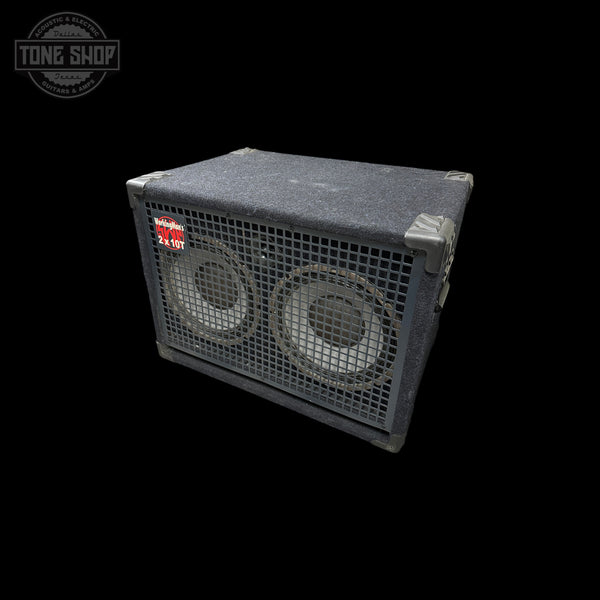 A vintage black speaker cabinet with two large front-facing speakers behind metal grilles, shown at an angle on a solid black background. A Tone Shop watermark is visible in the top-left corner.