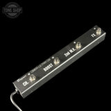 Guitar effects pedal with labeled switches on a black background