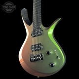 A PRS electric guitar with a metallic iridescent finish shifting from bronze to olive green, featuring a black neck and hardware, set against a solid black background.