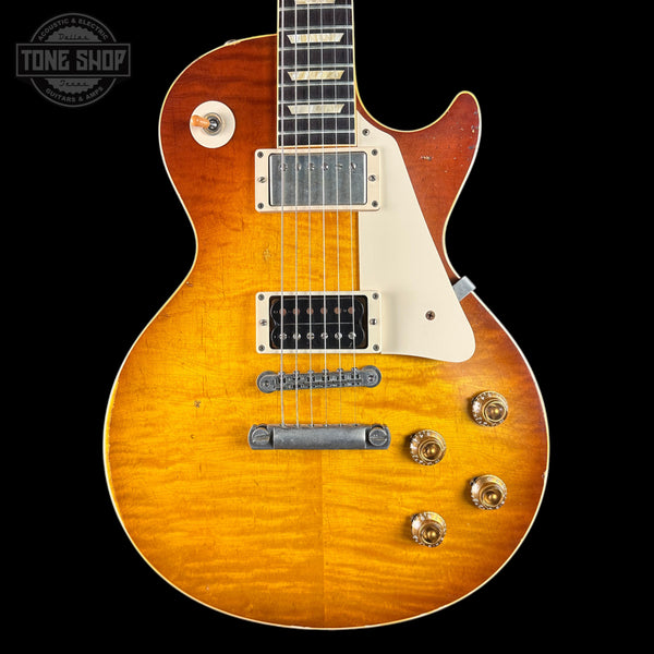 Electric guitar with a sunburst finish on a black background, featuring the Tone Shop logo.