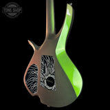 A custom electric guitar body shown from the back against a solid black background, featuring a metallic bronze finish with a vibrant neon green accent stripe and black-and-white zebra-patterned pickguard covers.