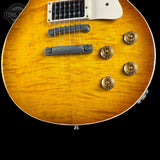 Close-up of a sunburst electric guitar with visible brand logo.
