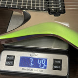 A close-up of a guitar body resting on a digital scale, showing the scale reading 7.49 lbs.
