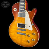 Electric guitar with a sunburst finish on a black background, featuring the Tone Shop logo.