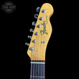Fender Telecaster guitar headstock on a black background