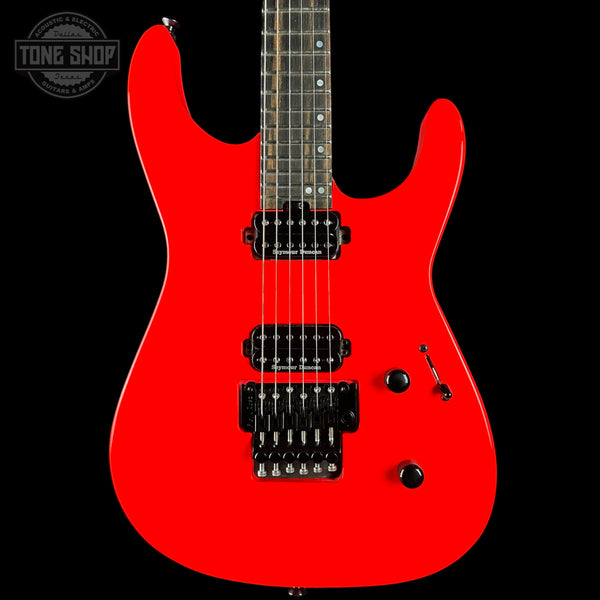 Red electric guitar on a black background, featuring the Tone Shop logo.
