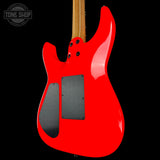 Red electric guitar with a black pickguard on a black background, featuring 'Tone Shop' logo.