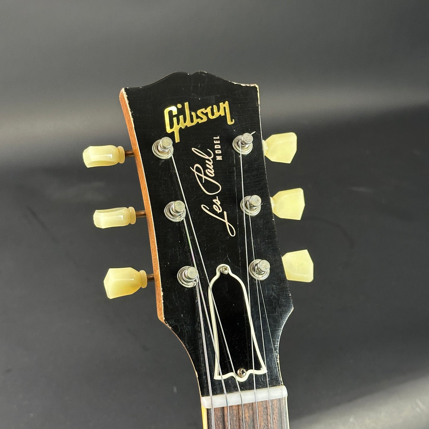 Gibson Les Paul guitar headstock on a dark background