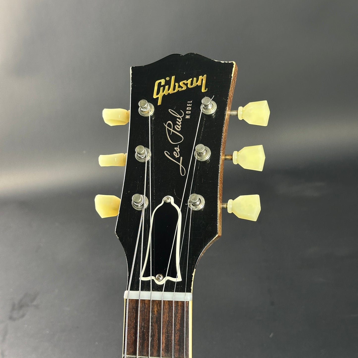 Gibson Les Paul guitar headstock on a dark background