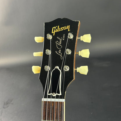Gibson Les Paul guitar headstock on a dark background