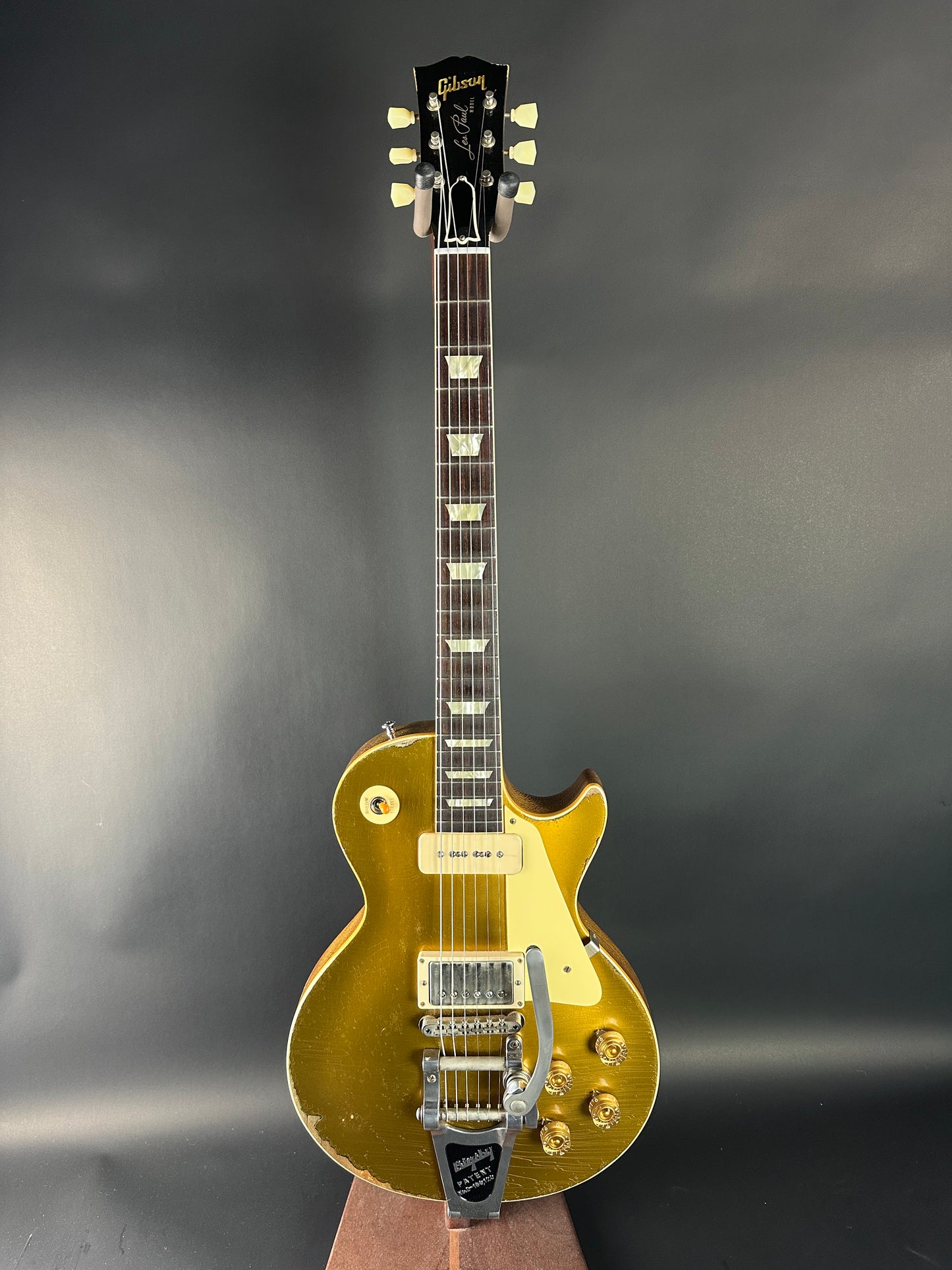 Gold electric guitar on a gray background