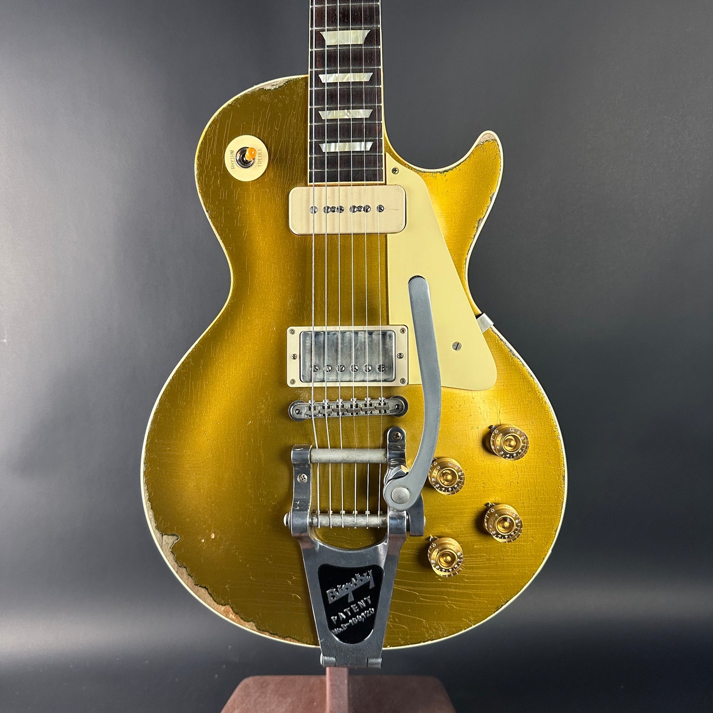 Gold electric guitar on a dark gray background