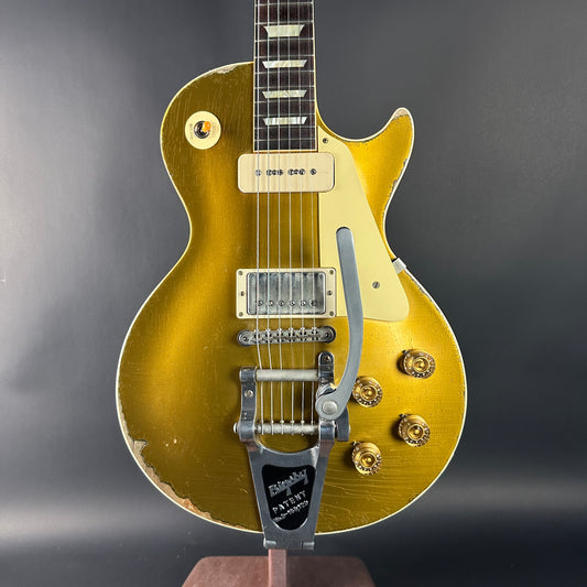 Gold electric guitar on a dark gray background