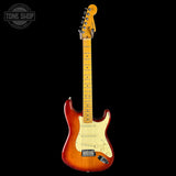 Electric guitar with a sunburst finish on a black background, featuring the Tone Shop logo.