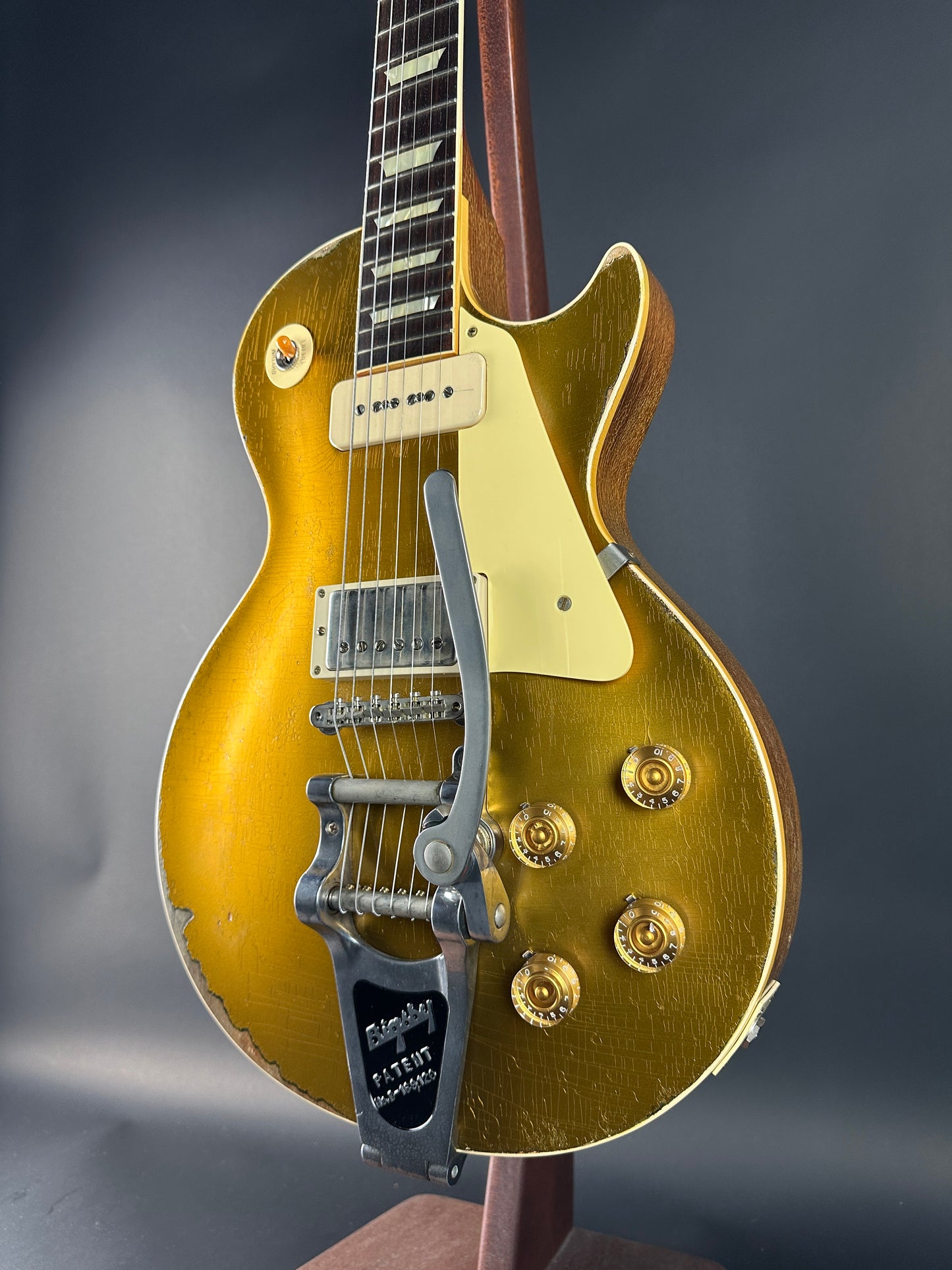 Gold electric guitar on a dark gray background