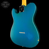 Blue electric guitar body with Fender logo on a black background