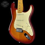 Electric guitar with a sunburst finish on a black background, featuring the Tone Shop logo.