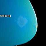 Close-up of a blue guitar with a circular pickguard and tuning pegs.