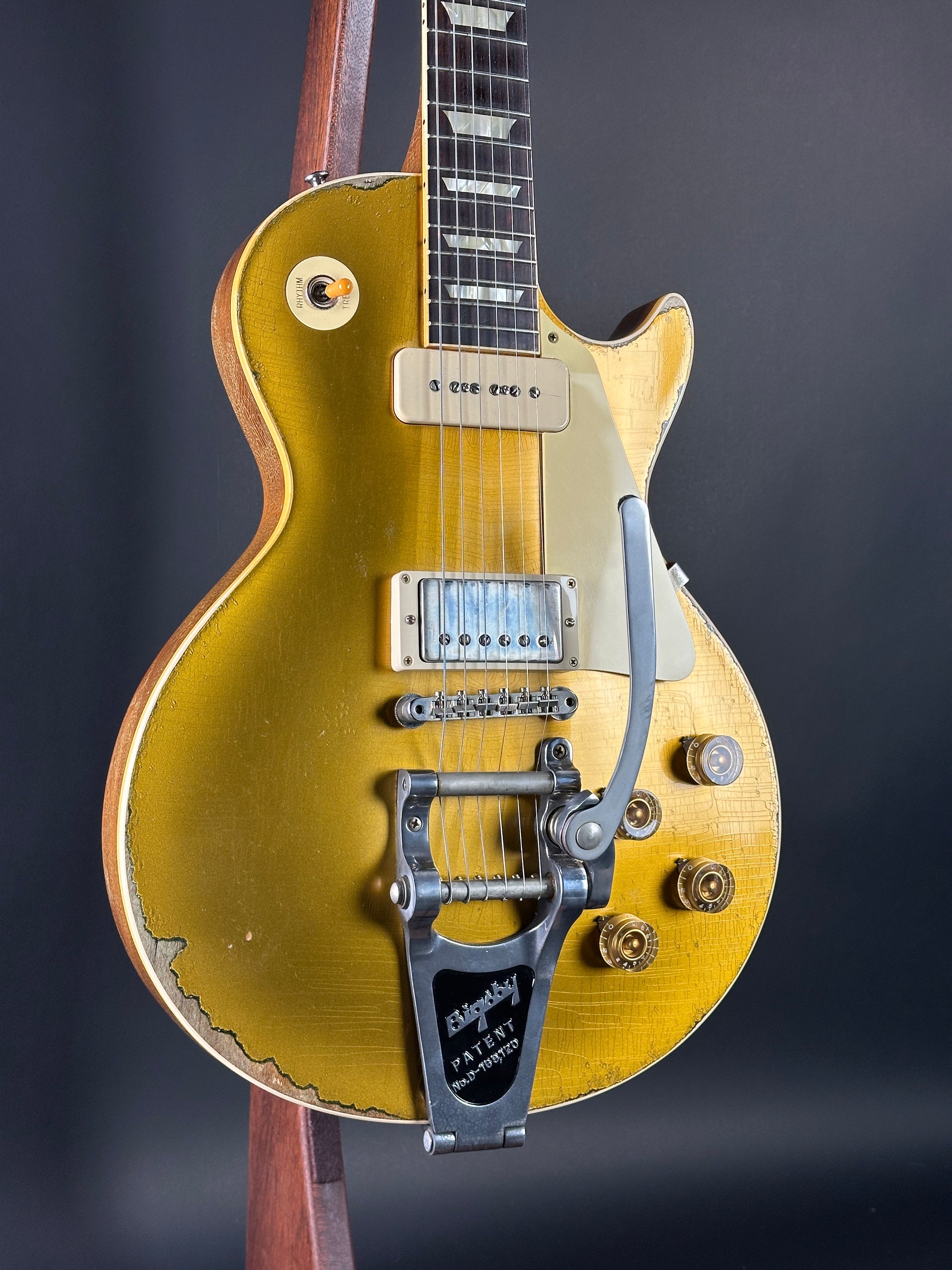 Gold electric guitar on a dark background