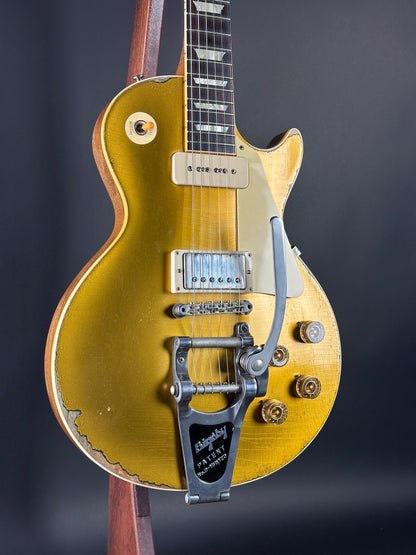 Gold electric guitar on a dark background