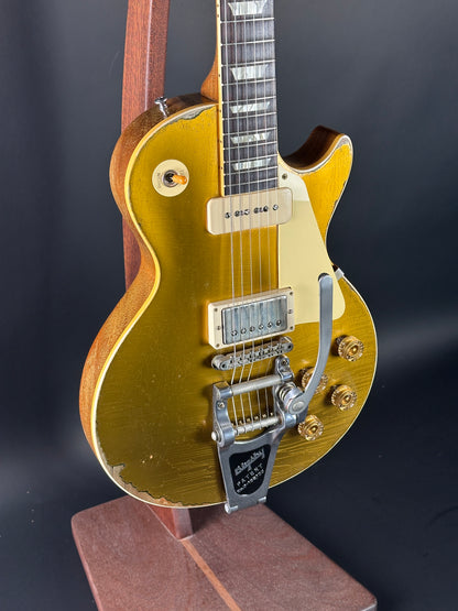 Gold electric guitar on a black background