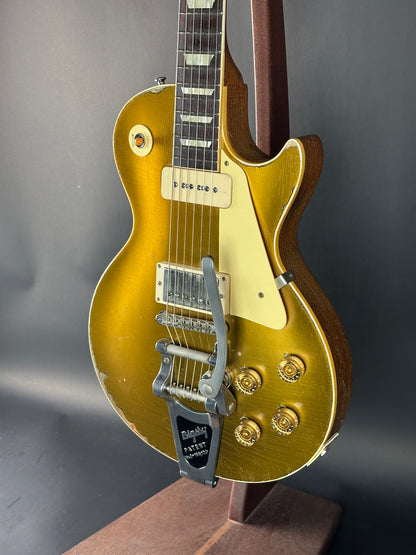 Gold electric guitar on a dark background