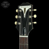 Close-up of the headstock of an Epiphone acoustic guitar against a black background, showing six cream-colored tuning pegs and the Epiphone logo on the dark fretboard.