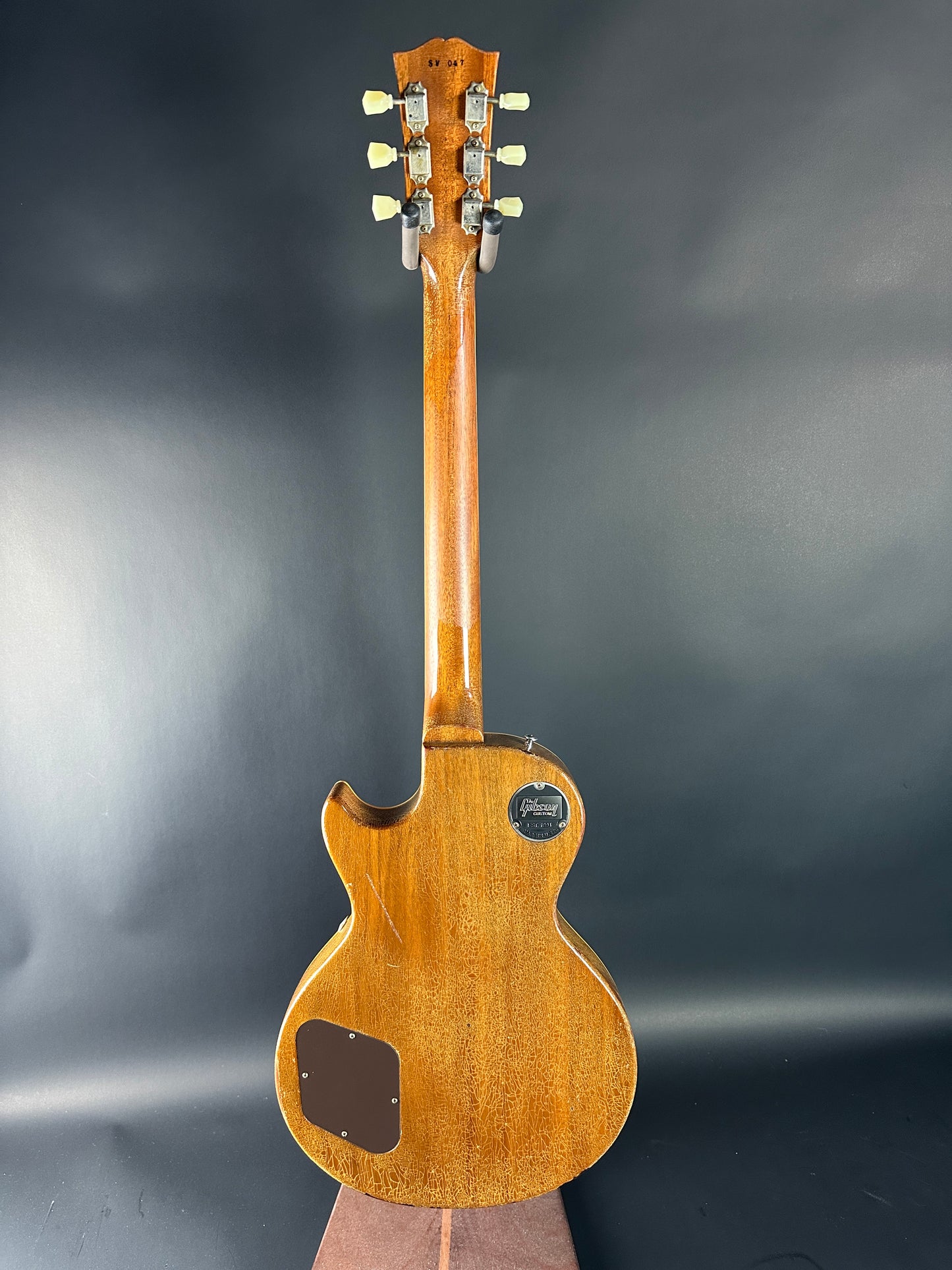 Wooden electric guitar on a dark background