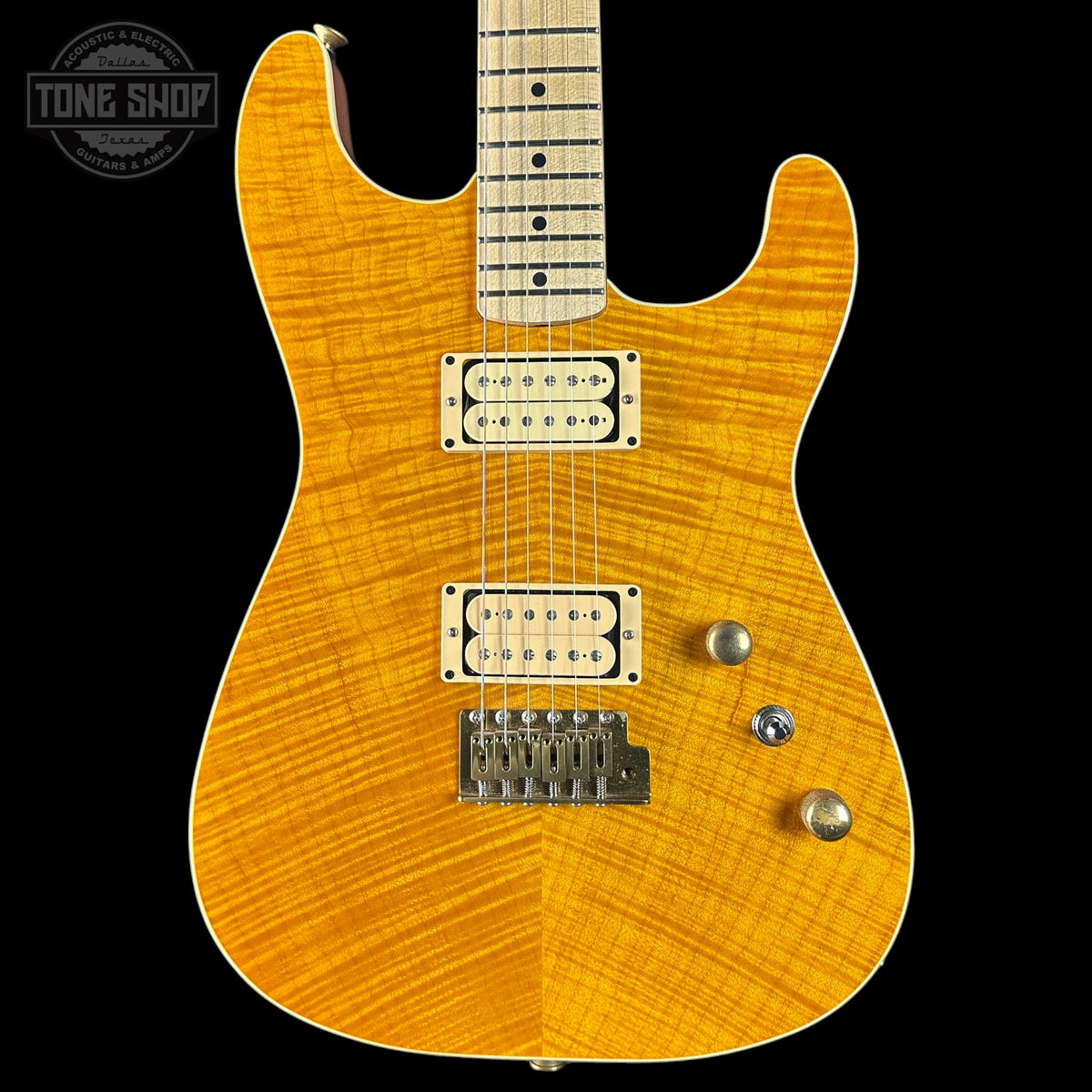 Electric guitar with a sunburst finish on a black background, featuring 'Tone Shop' branding.