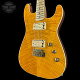 Electric guitar with a sunburst finish on a black background, featuring the Tone Shop logo.