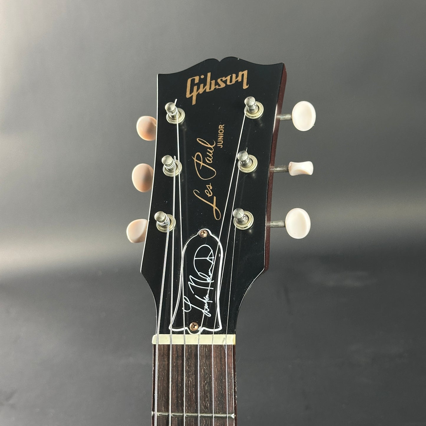 Gibson Les Paul Junior guitar headstock on a gray background
