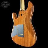 Back view of a wooden electric guitar with 'Tone Shop' logo in the corner.