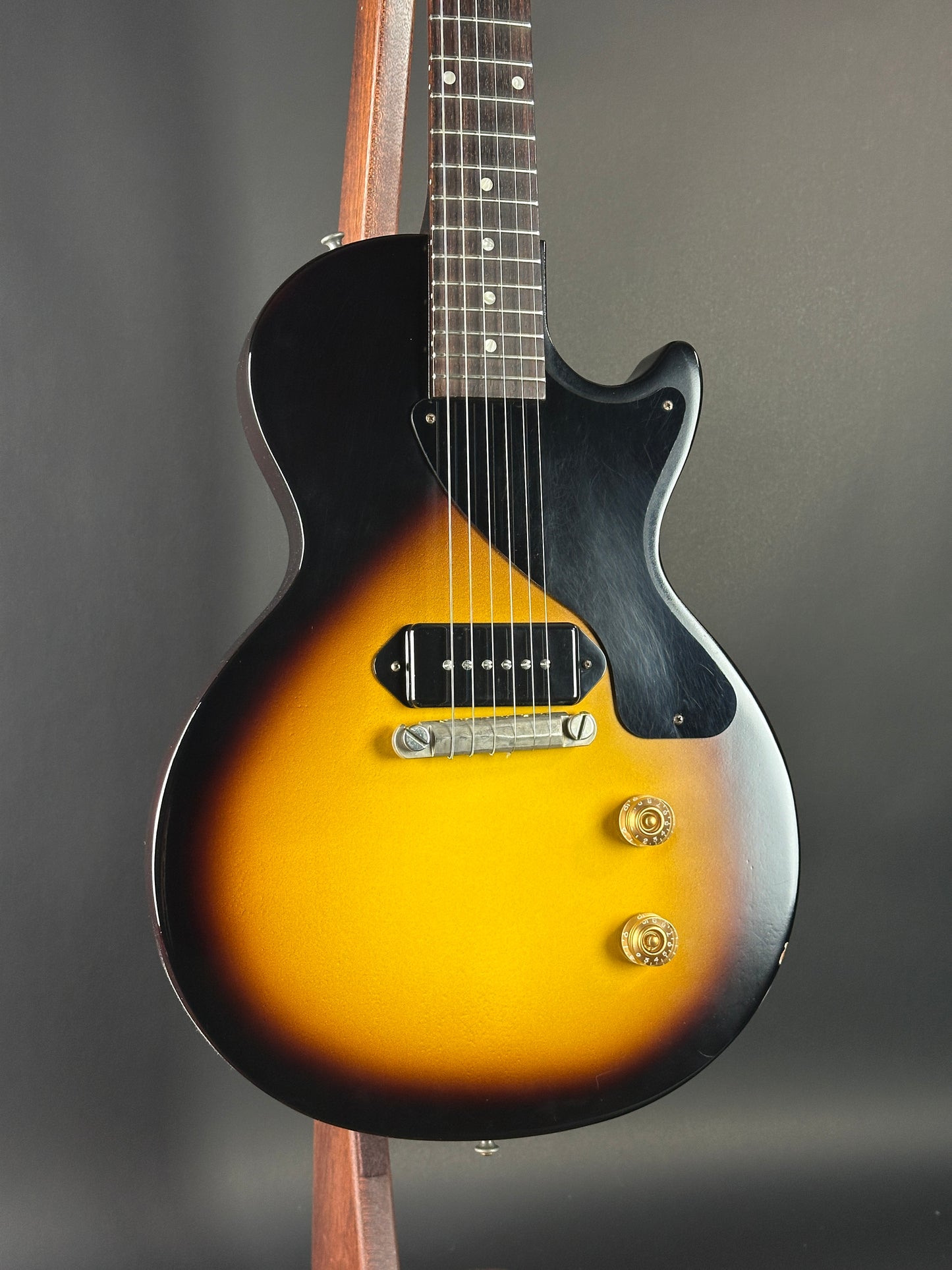 Electric guitar with a sunburst finish on a dark background