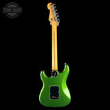 A green electric guitar shown from the back against a solid black background, with a Tone Shop watermark in the top-left corner.