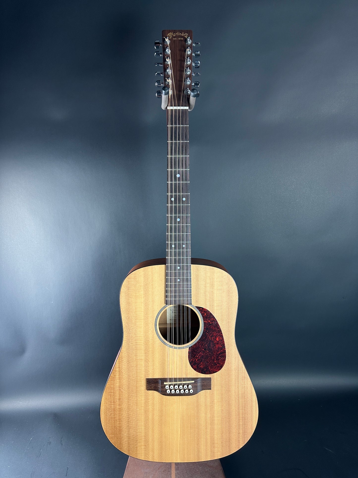 Acoustic guitar with a dark blue gradient background