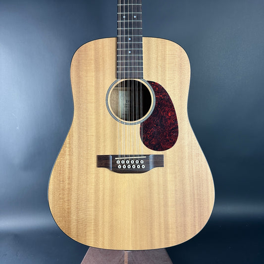 Acoustic guitar with a wooden finish on a dark blue background