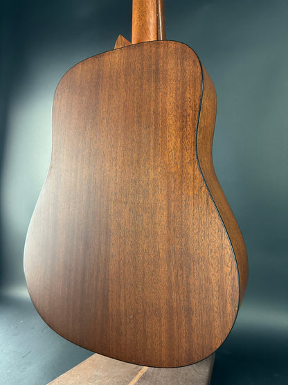 Close-up of a wooden acoustic guitar body on a dark background