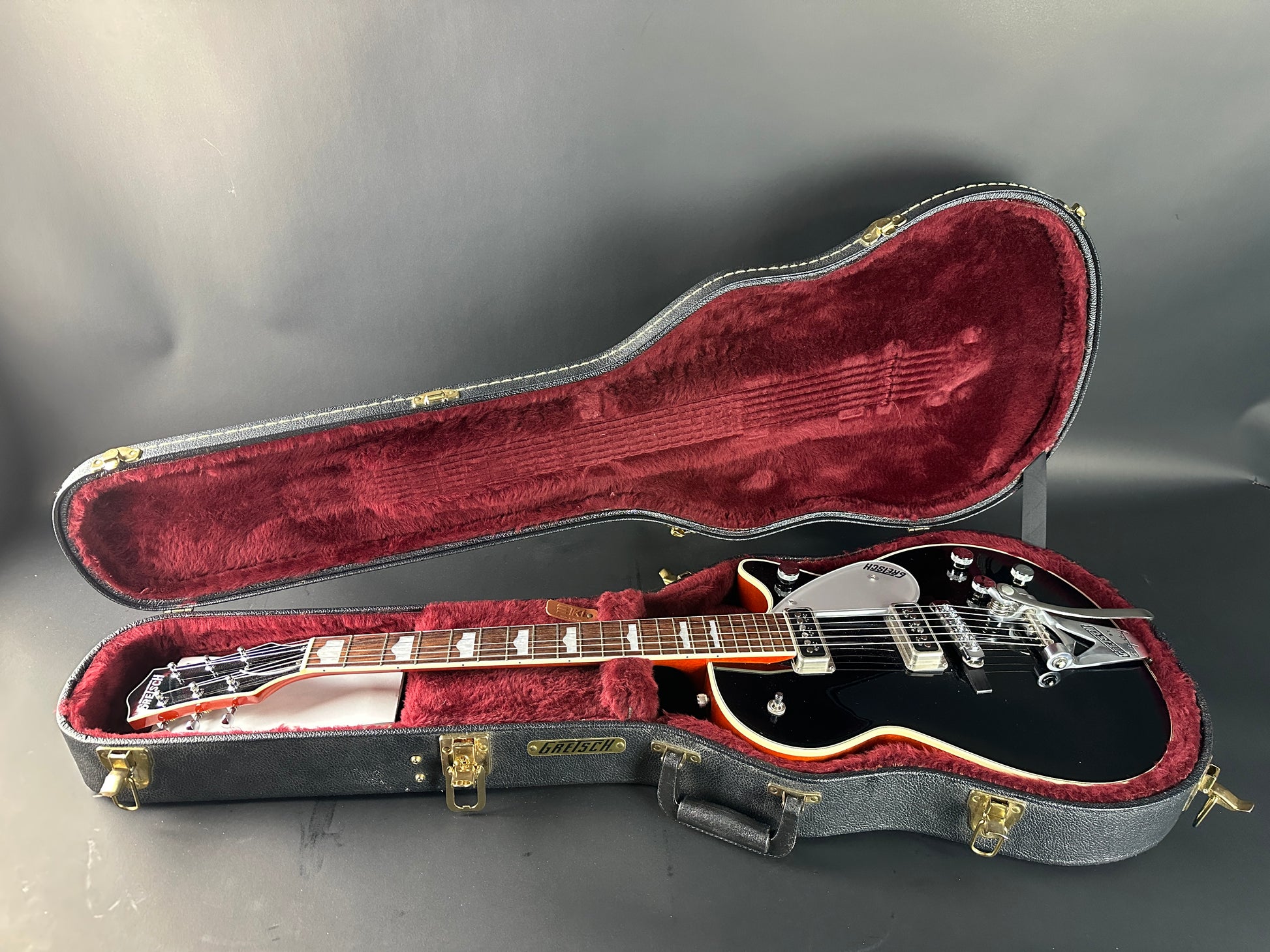 Guitar in a case on a gray background